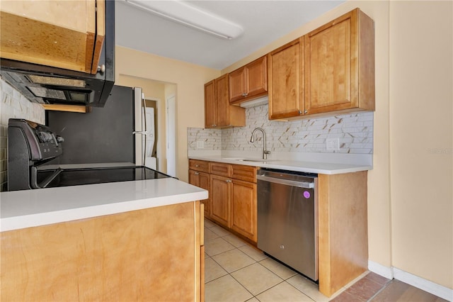 1695 Lee Rd Unit E103, Winter Park, FL 32789 - kitchen with appliances with stainless steel finishes, a sink, backsplash, light tile patterned flooring, and light countertops