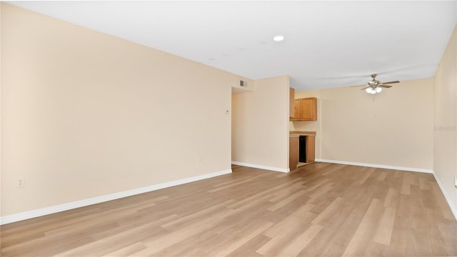 1695 Lee Rd Unit E103, Winter Park, FL 32789 - unfurnished living room featuring light wood-style flooring, ceiling fan, and baseboards