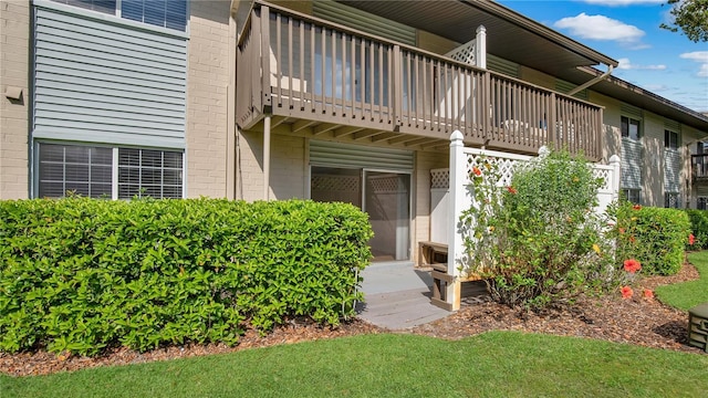 1695 Lee Rd Unit E103, Winter Park, FL 32789 - view of exterior entry featuring a balcony and brick siding