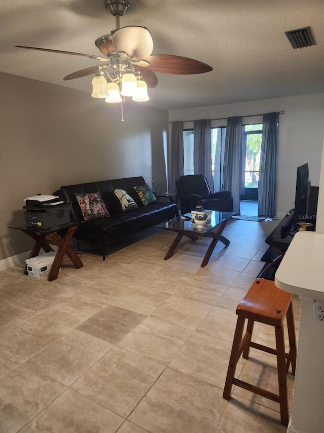 living room with visible vents and a textured ceiling