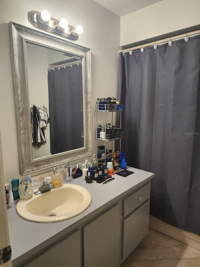 bathroom with tile patterned flooring and vanity