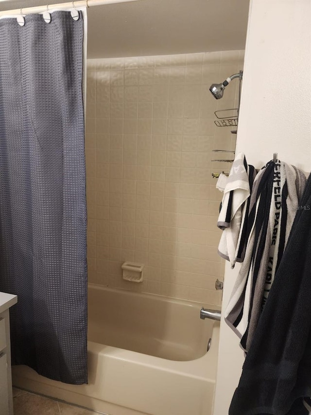 full bath with tile patterned floors, vanity, and shower / bath combo with shower curtain