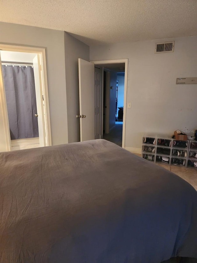 bedroom with visible vents and a textured ceiling