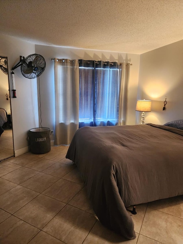 tiled bedroom with a textured ceiling