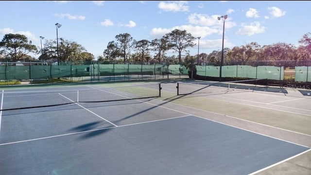 view of tennis court featuring fence