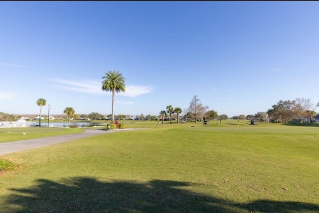 view of home's community featuring a water view and a yard