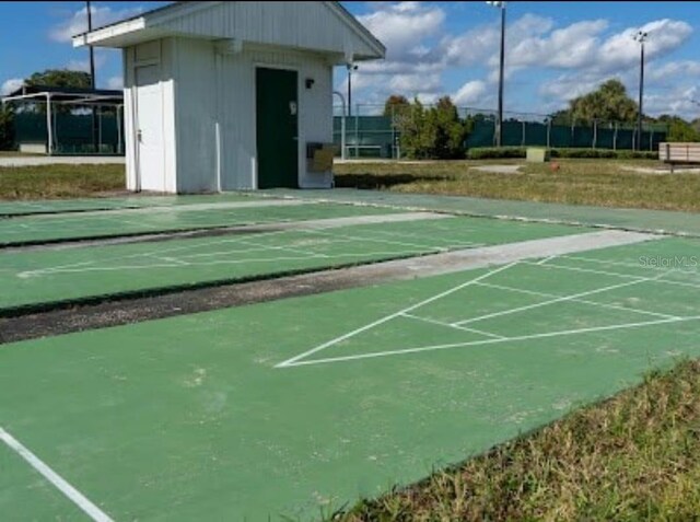 view of home's community featuring shuffleboard