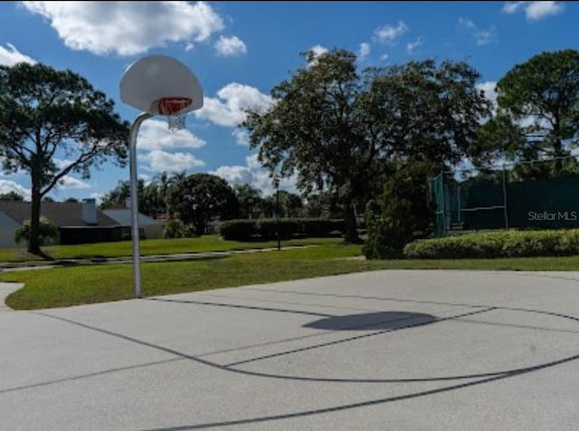 view of basketball court with community basketball court and a yard