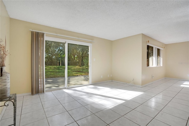 406 Oak Haven Dr Unit 406, Altamonte Springs, FL 32701 - empty room featuring a textured ceiling, baseboards, and light tile patterned floors