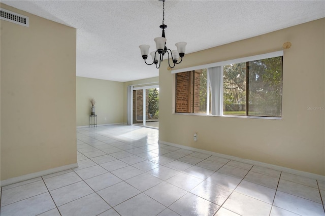 406 Oak Haven Dr Unit 406, Altamonte Springs, FL 32701 - unfurnished room with light tile patterned floors, visible vents, an inviting chandelier, a textured ceiling, and baseboards
