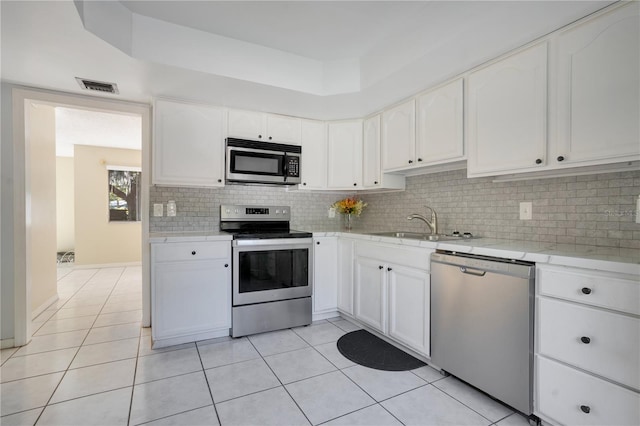 406 Oak Haven Dr Unit 406, Altamonte Springs, FL 32701 - kitchen featuring stainless steel appliances, a sink, visible vents, white cabinetry, and light countertops