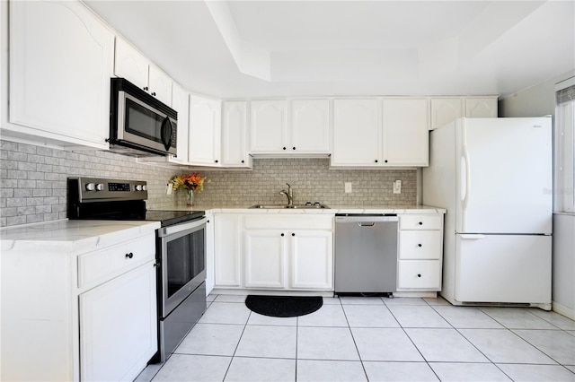 406 Oak Haven Dr Unit 406, Altamonte Springs, FL 32701 - kitchen with a sink, a tray ceiling, stainless steel appliances, and light countertops
