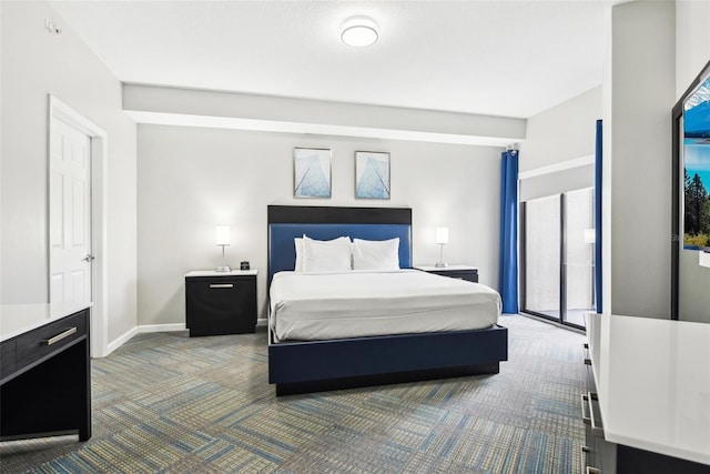 bedroom featuring dark colored carpet and baseboards