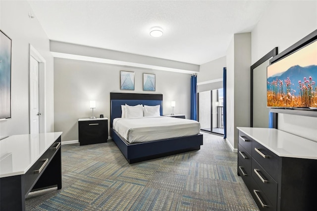 bedroom featuring dark colored carpet and baseboards