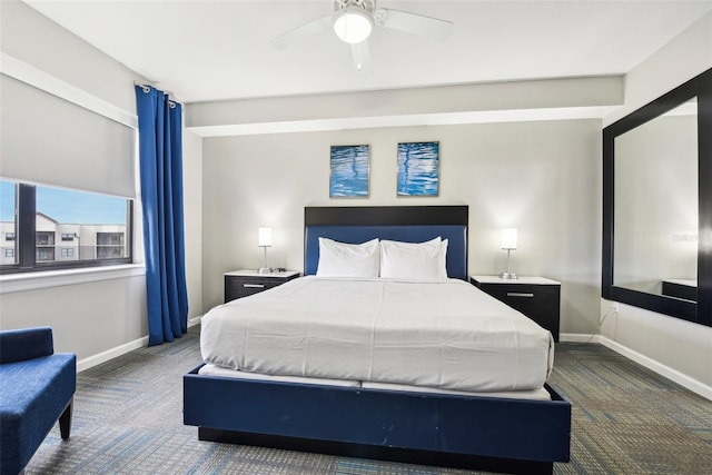 bedroom featuring a ceiling fan, dark colored carpet, and baseboards