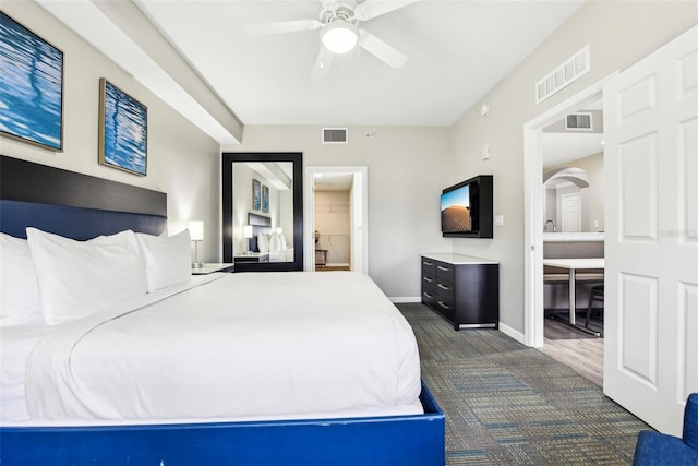 bedroom featuring arched walkways, visible vents, and baseboards