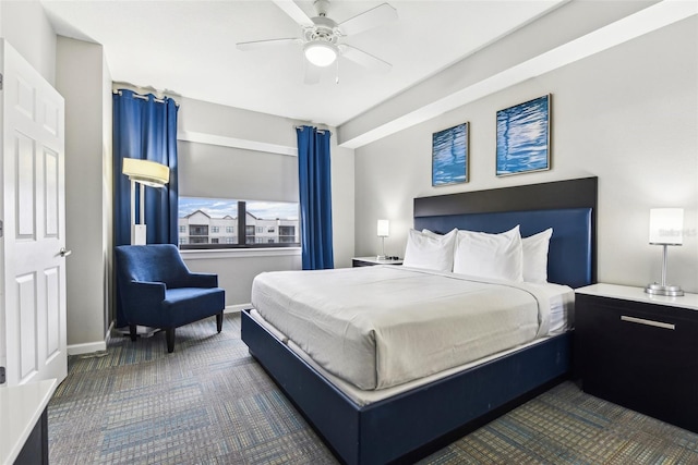 bedroom with dark carpet, baseboards, and ceiling fan