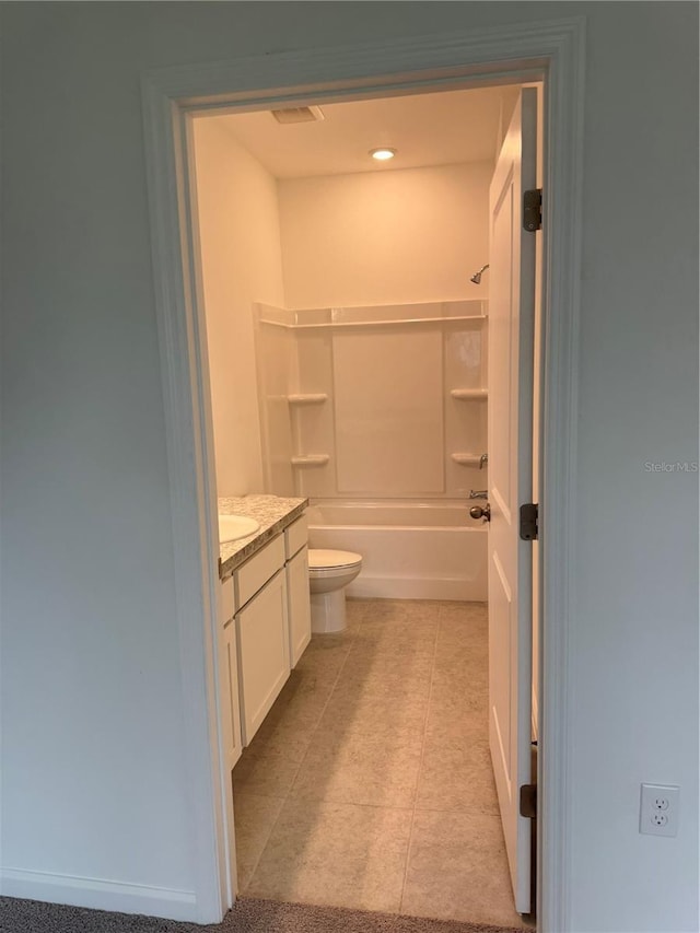 bathroom featuring toilet, bathtub / shower combination, vanity, and tile patterned floors