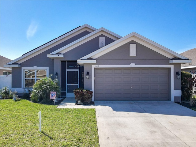 view of front of house featuring driveway, a front lawn, an attached garage, and stucco siding