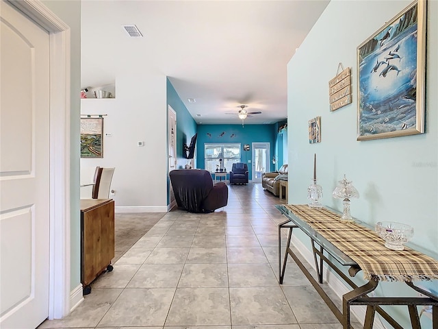 649 Meadow Pointe Dr, Haines City, FL 33844 - hall with visible vents, baseboards, and light tile patterned flooring