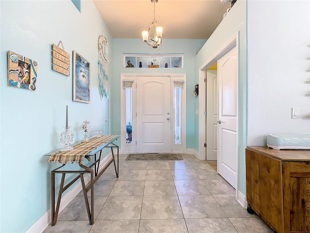 649 Meadow Pointe Dr, Haines City, FL 33844 - foyer entrance featuring a notable chandelier, light tile patterned flooring, and baseboards