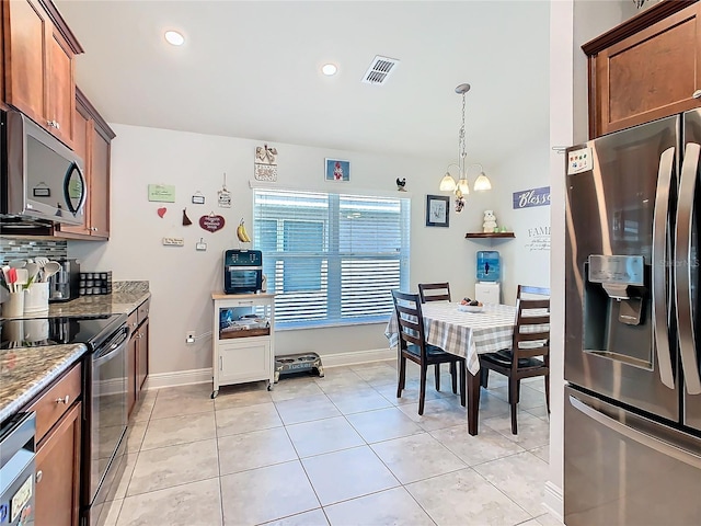 649 Meadow Pointe Dr, Haines City, FL 33844 - kitchen featuring light stone counters, visible vents, decorative backsplash, appliances with stainless steel finishes, and a chandelier