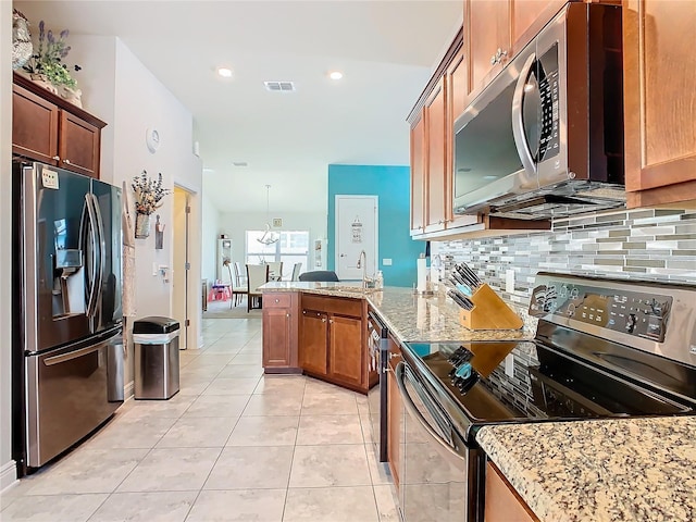 649 Meadow Pointe Dr, Haines City, FL 33844 - kitchen featuring visible vents, backsplash, appliances with stainless steel finishes, a peninsula, and light tile patterned floors
