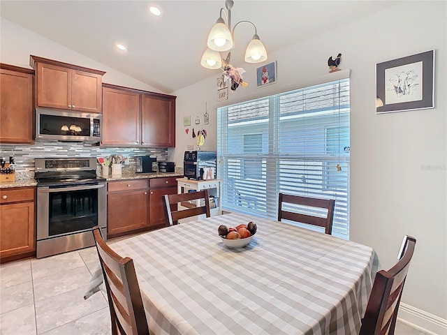 649 Meadow Pointe Dr, Haines City, FL 33844 - dining room with an inviting chandelier, lofted ceiling, light tile patterned floors, and recessed lighting