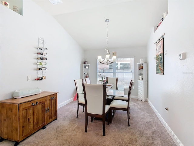649 Meadow Pointe Dr, Haines City, FL 33844 - dining room featuring an inviting chandelier, light colored carpet, baseboards, and lofted ceiling