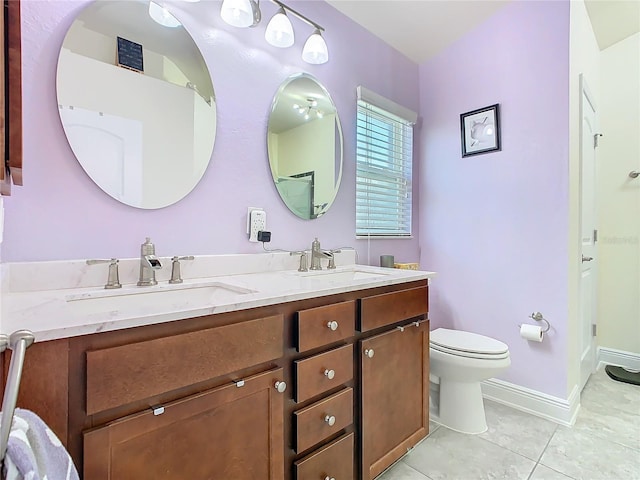 649 Meadow Pointe Dr, Haines City, FL 33844 - bathroom featuring tile patterned floors, double vanity, toilet, and a sink