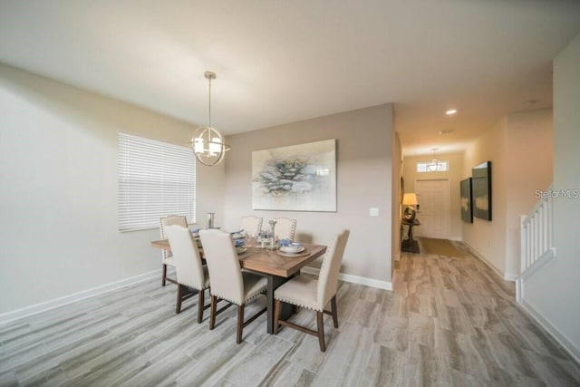 dining space with light wood-style flooring, baseboards, and recessed lighting