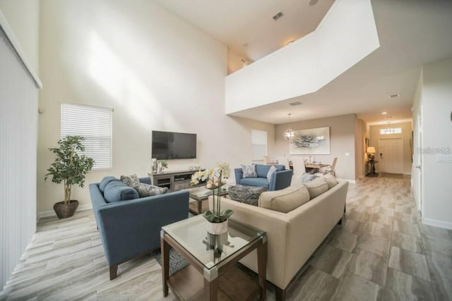1646 Moon Valley Dr, Davenport, FL 33896 - living room featuring a high ceiling and baseboards