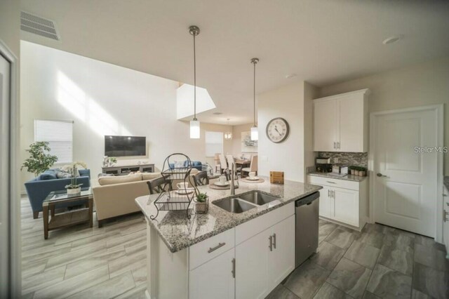 1646 Moon Valley Dr, Davenport, FL 33896 - kitchen with visible vents, white cabinets, dishwasher, open floor plan, and a sink