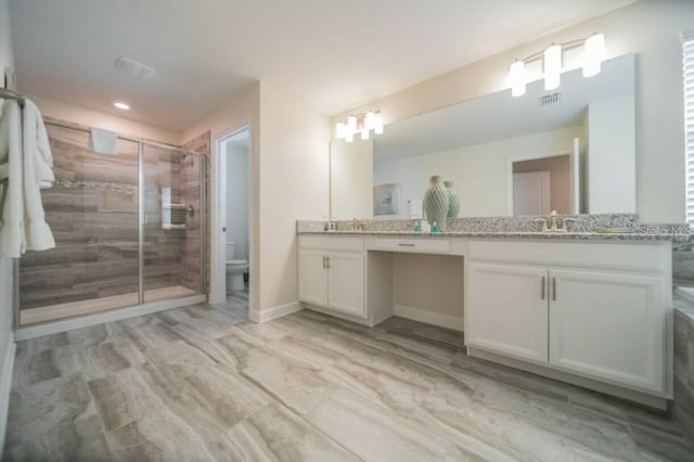 1646 Moon Valley Dr, Davenport, FL 33896 - full bath featuring double vanity, visible vents, toilet, a sink, and a shower stall