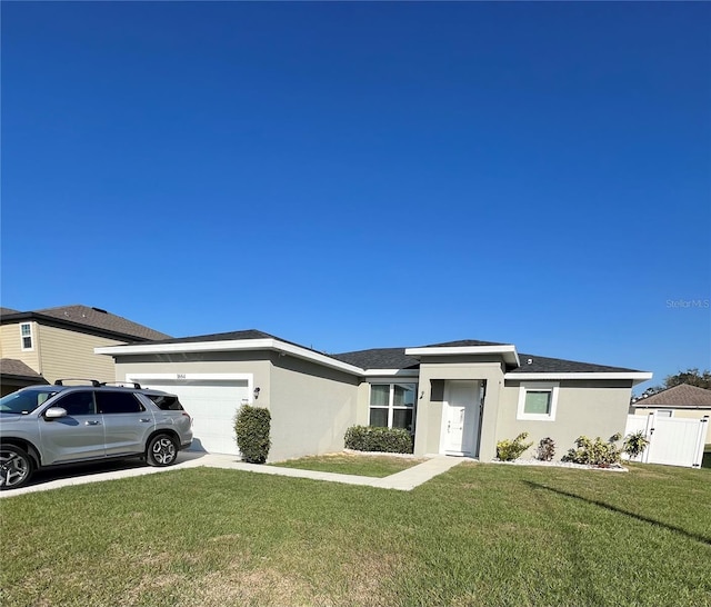view of front of home with an attached garage, a front yard, concrete driveway, and stucco siding