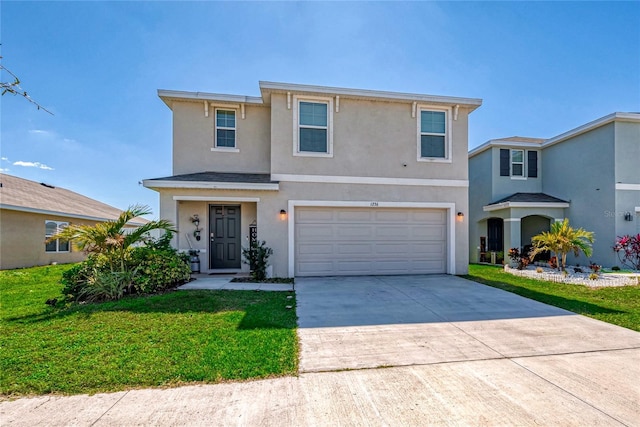 traditional home with a garage, driveway, a front lawn, and stucco siding