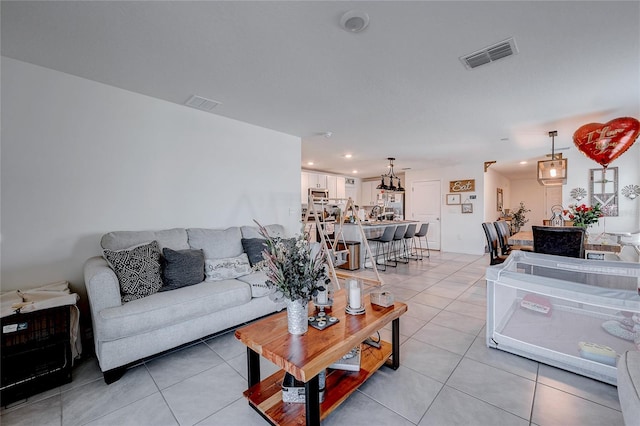 living area featuring light tile patterned floors, visible vents, and recessed lighting