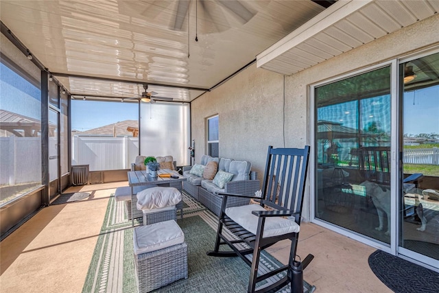 sunroom featuring a ceiling fan