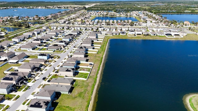 drone / aerial view with a water view and a residential view