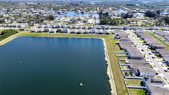 drone / aerial view with a water view and a residential view