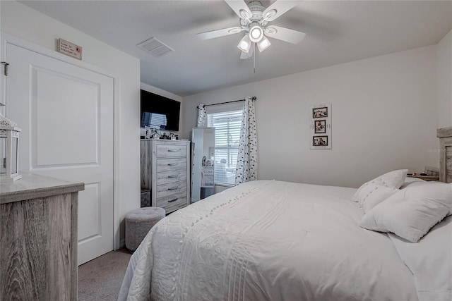 carpeted bedroom with ceiling fan and visible vents