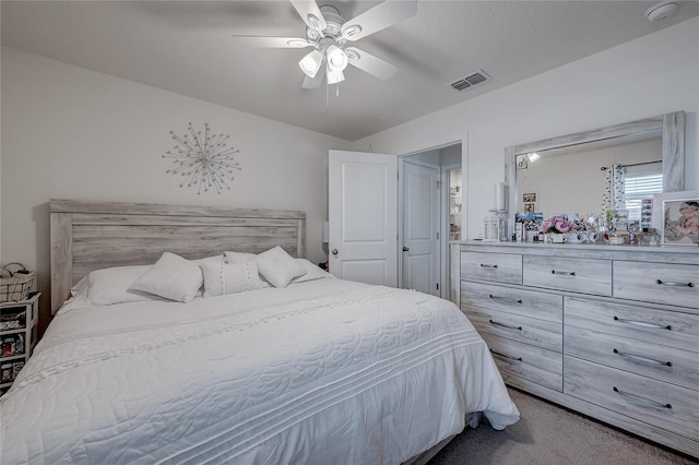 carpeted bedroom featuring visible vents and a ceiling fan