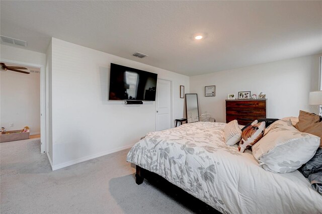 carpeted bedroom with visible vents and baseboards