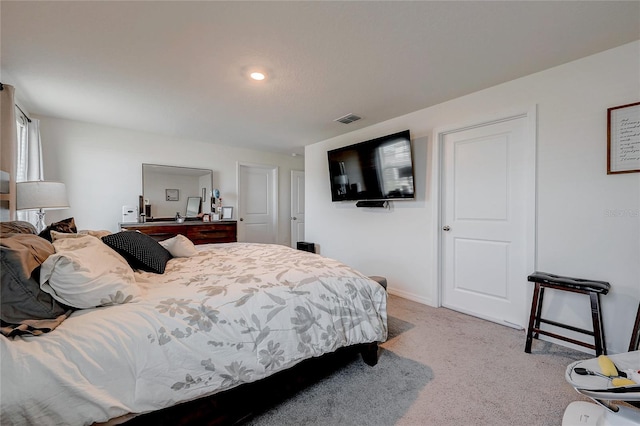 carpeted bedroom with visible vents and baseboards