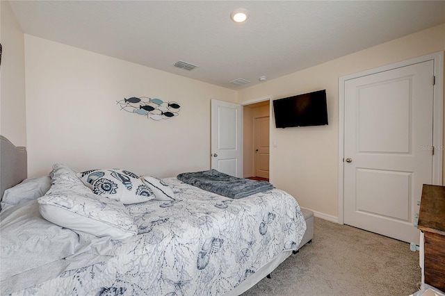 bedroom with light colored carpet, visible vents, and baseboards