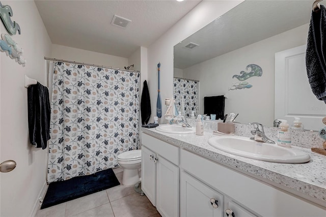 full bathroom featuring toilet, visible vents, a sink, and tile patterned floors