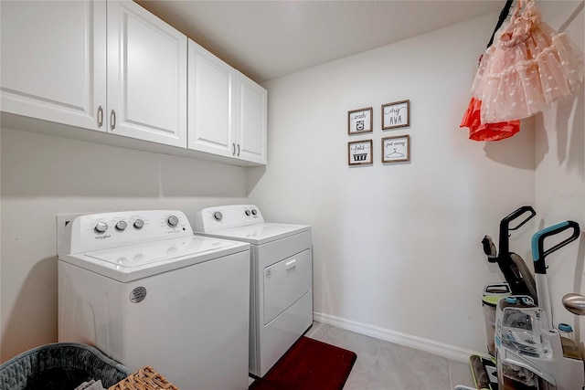 laundry room with cabinet space, independent washer and dryer, baseboards, and light tile patterned floors