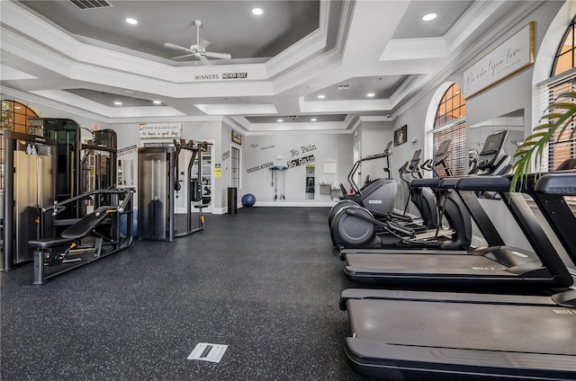 gym with a ceiling fan, ornamental molding, visible vents, and baseboards