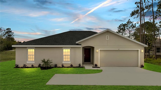 ranch-style home featuring a garage, a shingled roof, concrete driveway, a lawn, and stucco siding