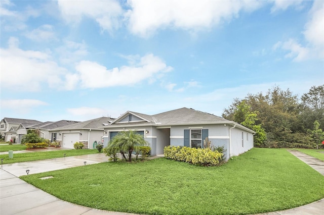 view of front of house featuring a garage, concrete driveway, a front yard, and stucco siding